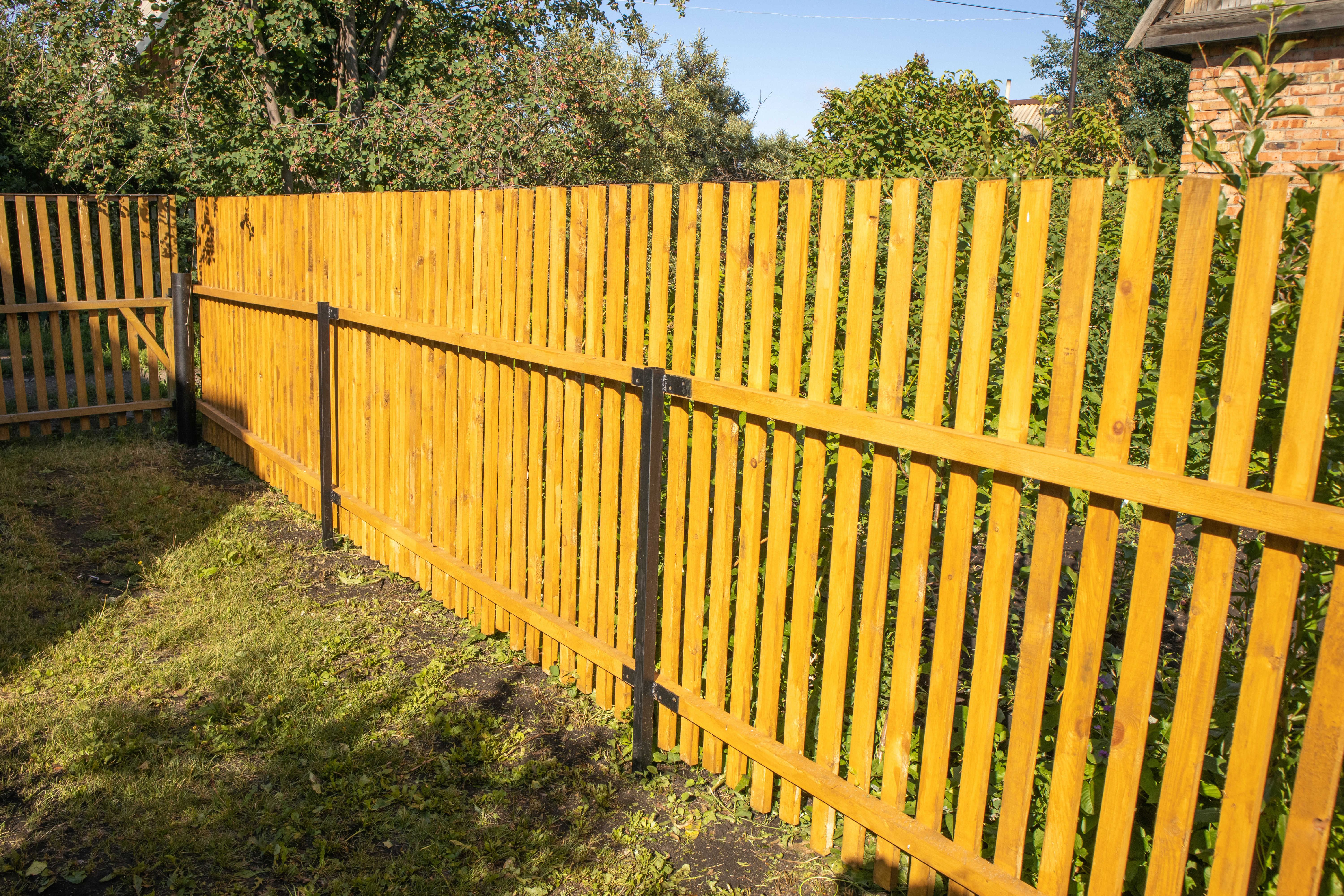 Close-up of new cedar fence boards and posts in Fulshear TX
