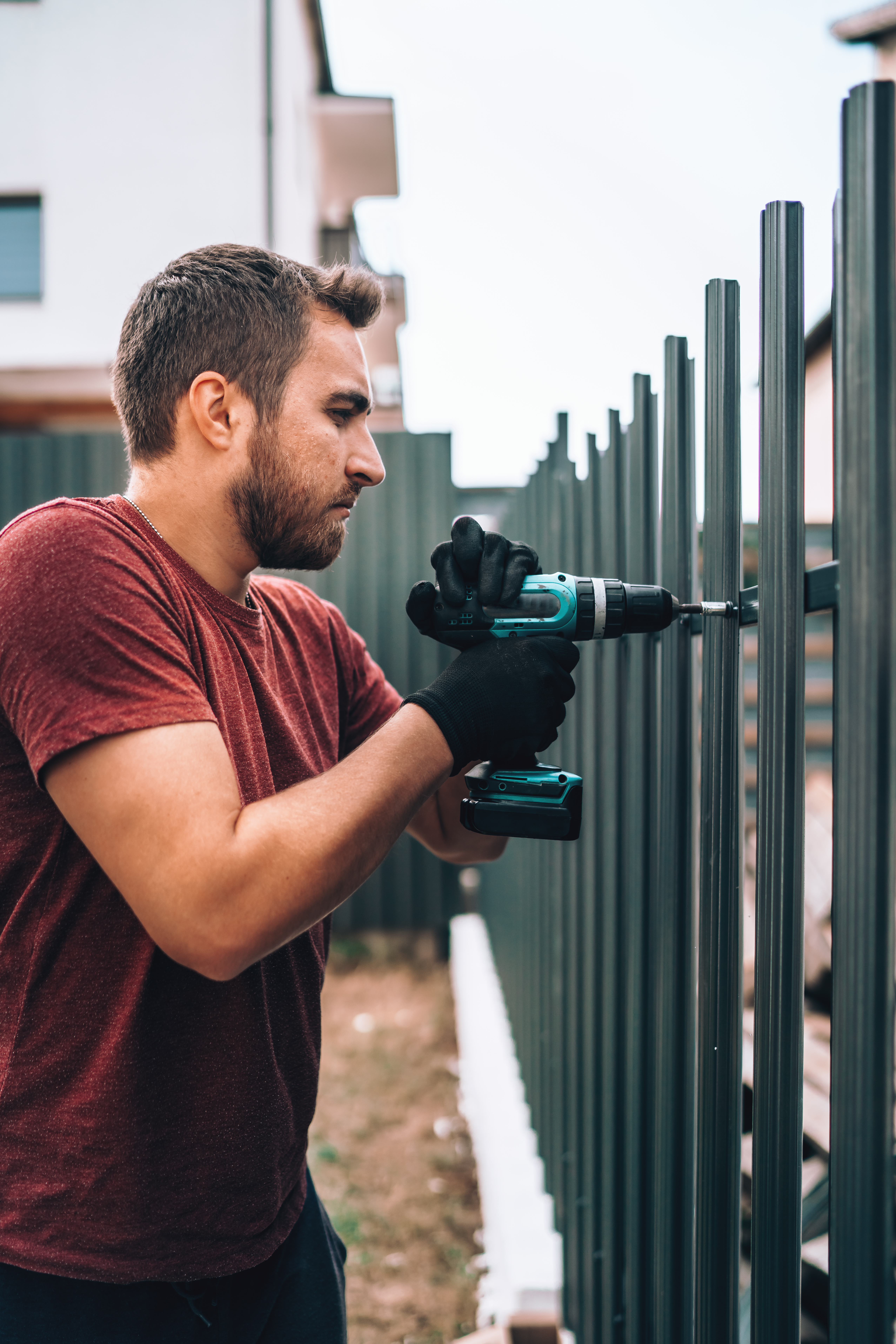 Fence repair contractor working on storm-damaged fence in Fulshear TX