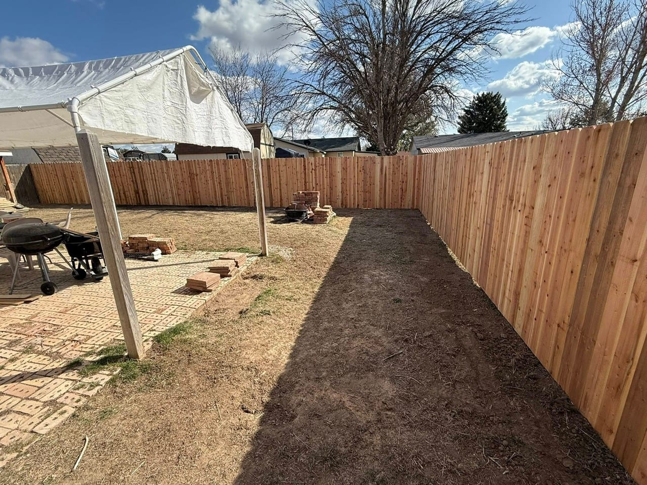 Fence repair contractor working on storm-damaged fence in Fulshear TX